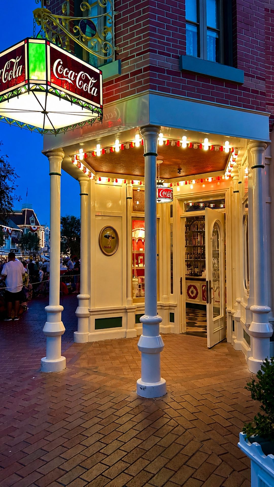 Coca-Cola Refreshment Corner lit up at blue hour